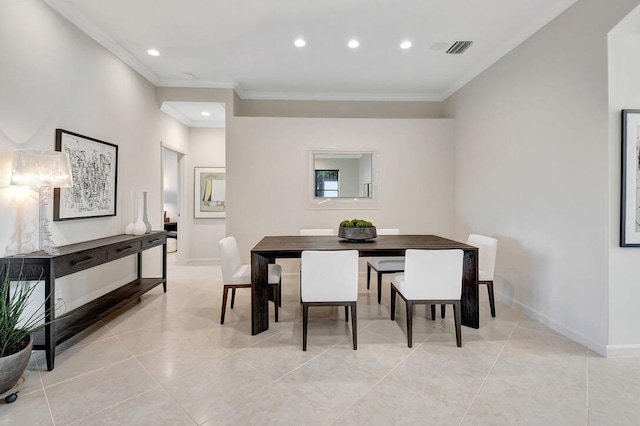 dining room with crown molding and light tile patterned floors