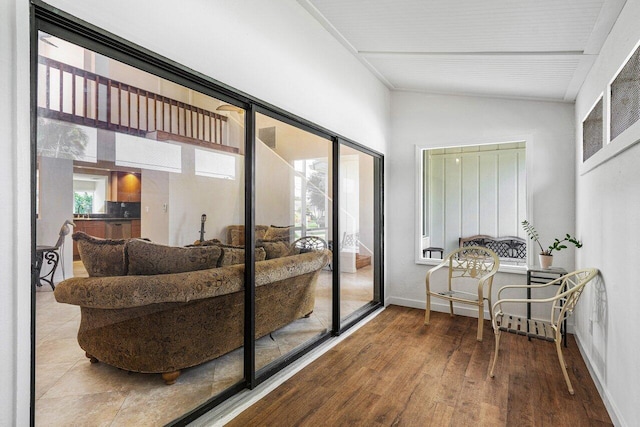 interior space featuring hardwood / wood-style flooring and lofted ceiling