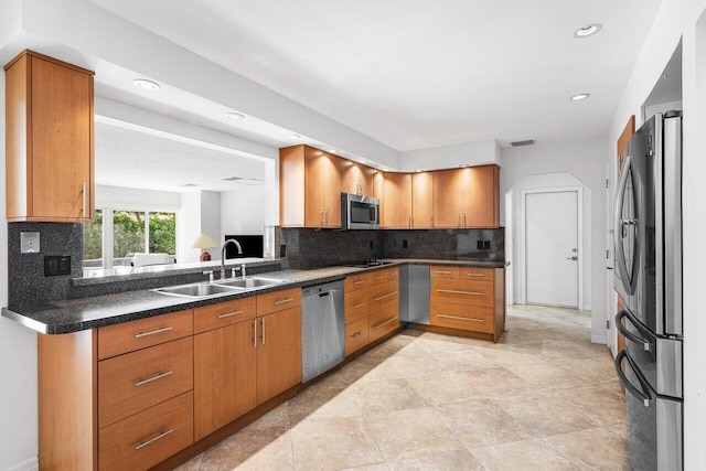 kitchen featuring backsplash, sink, light tile patterned floors, and stainless steel appliances