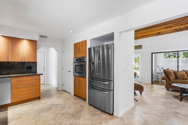 kitchen featuring decorative backsplash, light tile patterned floors, and appliances with stainless steel finishes