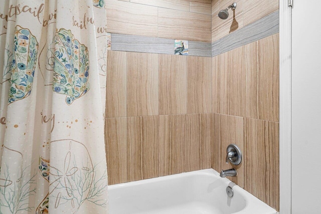 bathroom with shower / bath combo with shower curtain