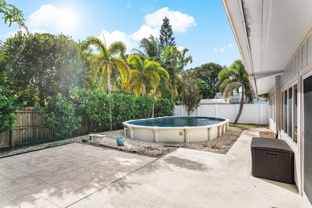 view of patio with a fenced in pool