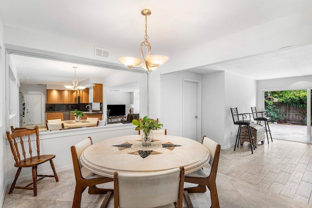 dining area with an inviting chandelier