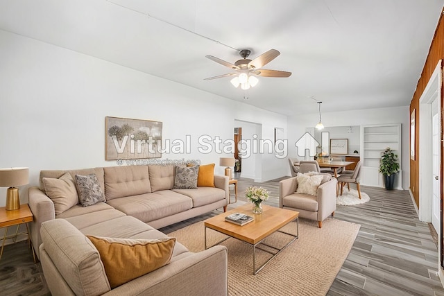 living room featuring hardwood / wood-style flooring and ceiling fan