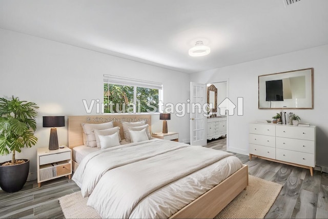 bedroom with dark wood-type flooring