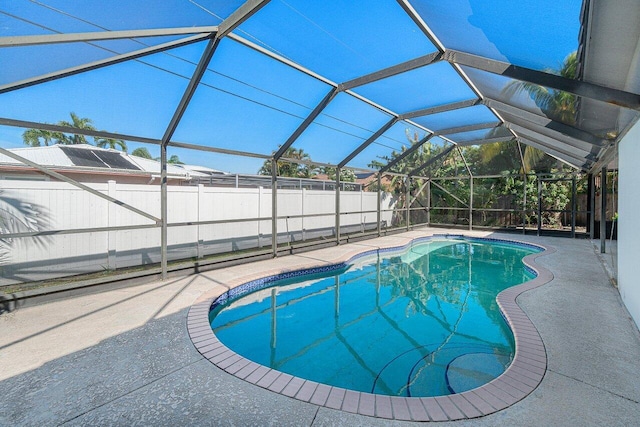 view of swimming pool featuring a lanai and a patio