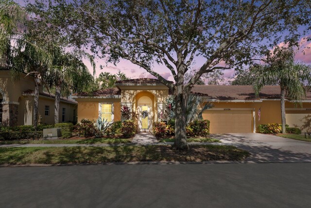 mediterranean / spanish-style house with a garage