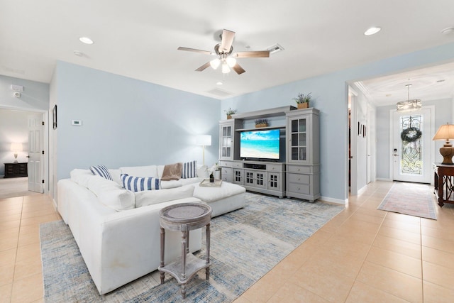 living room featuring ceiling fan and light tile patterned floors