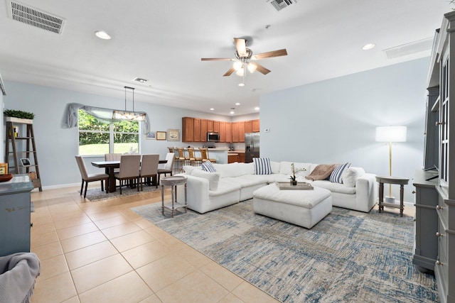 tiled living room featuring ceiling fan