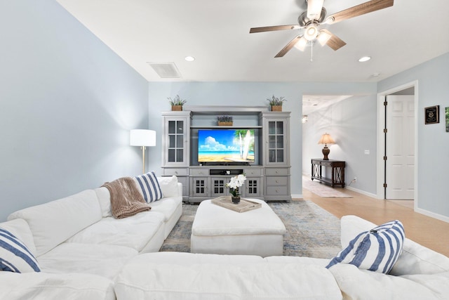 living room with light hardwood / wood-style floors and ceiling fan