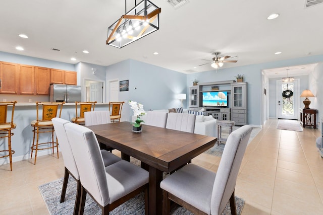 tiled dining space with ceiling fan