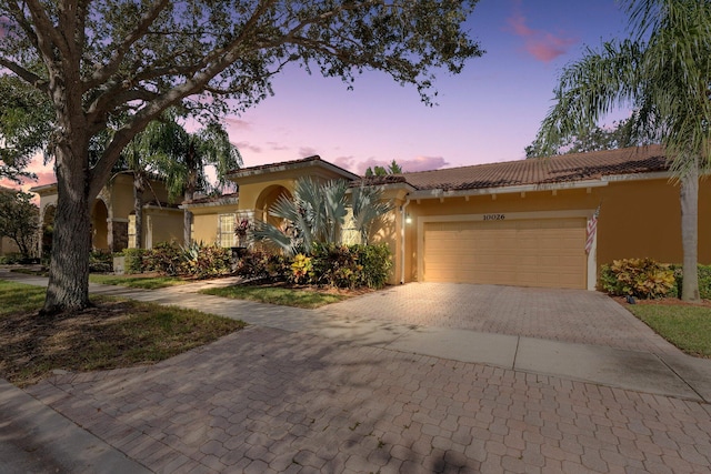 mediterranean / spanish house featuring a garage