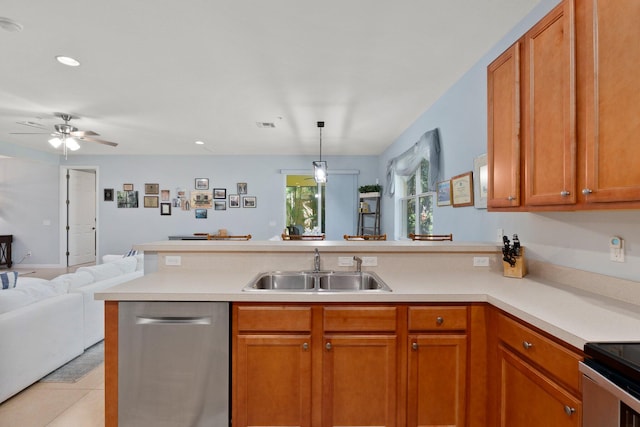 kitchen with light tile patterned floors, pendant lighting, sink, dishwasher, and kitchen peninsula