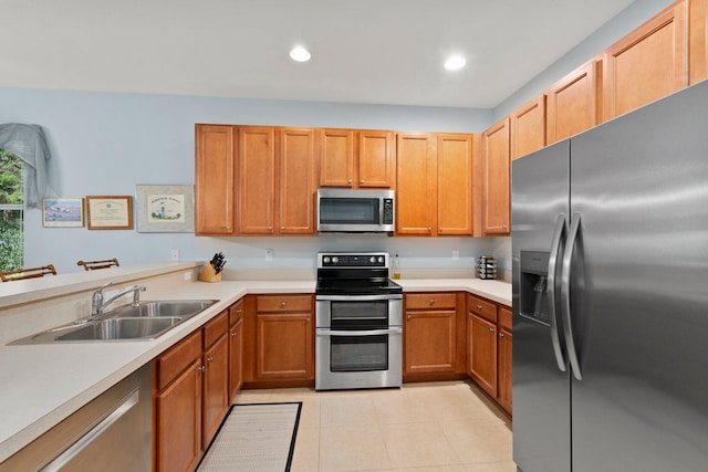 kitchen with light tile patterned floors, sink, and appliances with stainless steel finishes