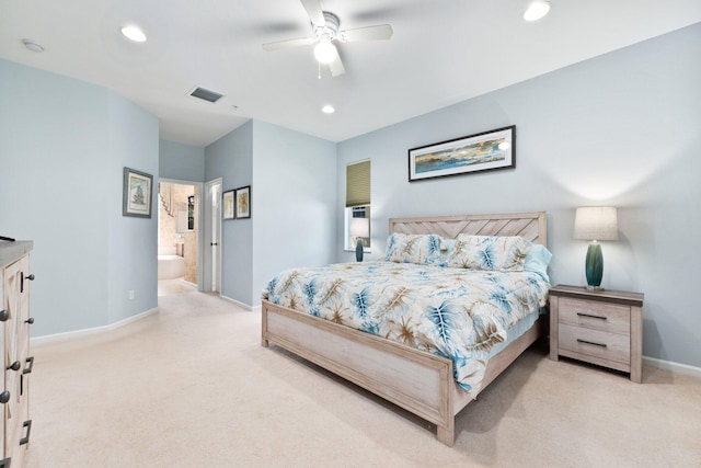 carpeted bedroom with ceiling fan and ensuite bath