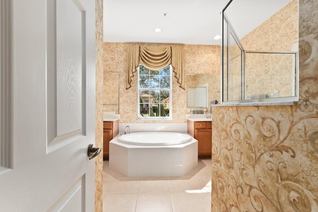 bathroom with vanity, tiled tub, and tile patterned floors