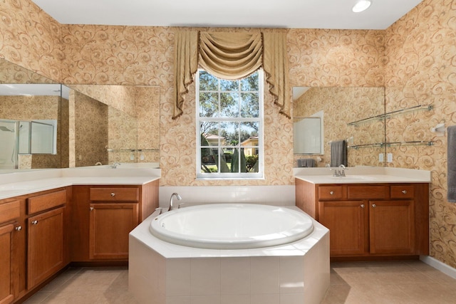 bathroom with vanity, tile patterned floors, and a relaxing tiled tub