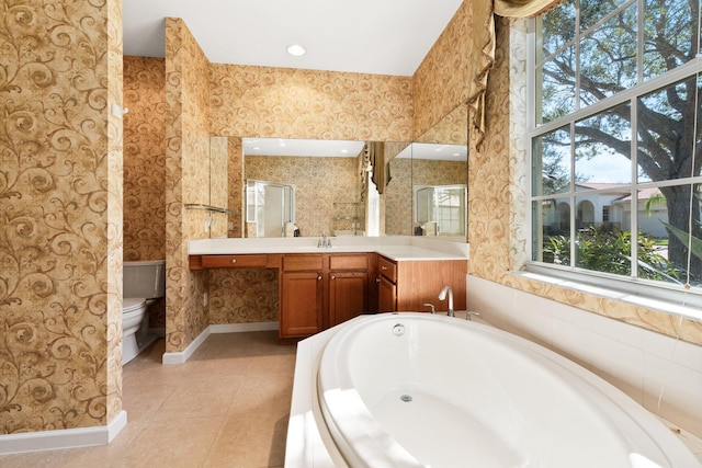 bathroom featuring a bath, tile patterned floors, vanity, and toilet