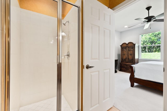 bedroom featuring ensuite bathroom, light colored carpet, and ceiling fan