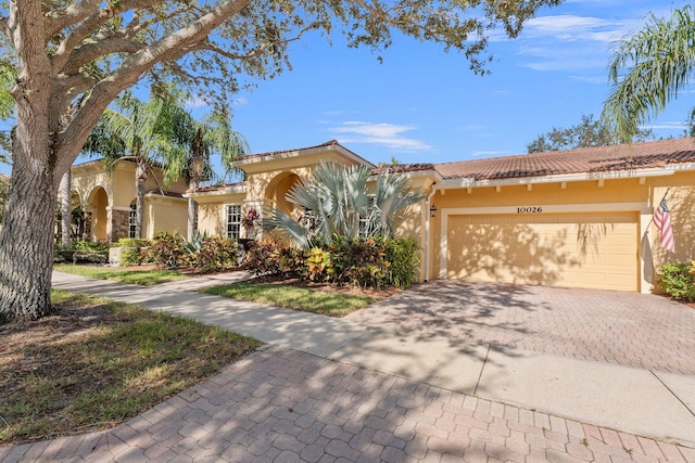 mediterranean / spanish-style house with a garage