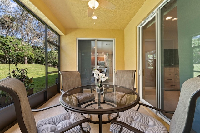 sunroom / solarium featuring ceiling fan