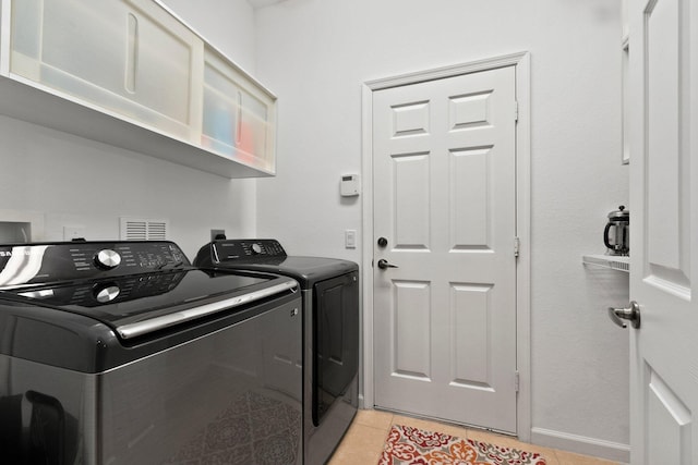 washroom featuring light tile patterned floors and separate washer and dryer