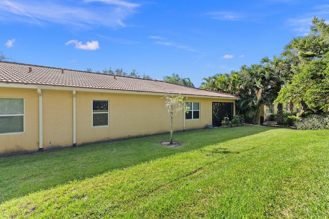 rear view of house featuring a yard