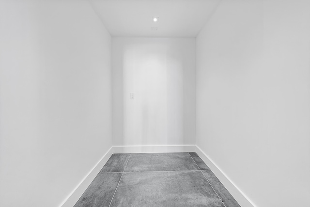 unfurnished room with baseboards