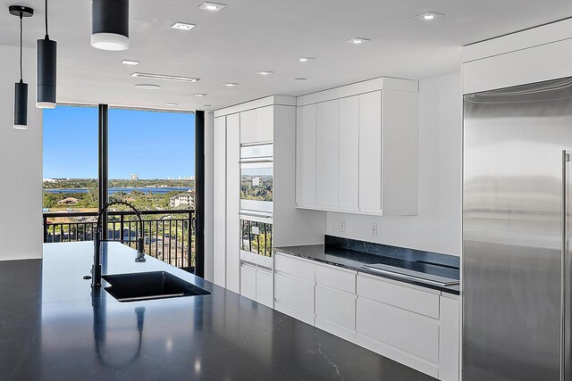 bedroom with floor to ceiling windows and access to outside