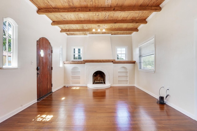 unfurnished living room with wooden ceiling, beamed ceiling, and wood-type flooring