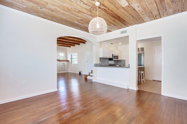 unfurnished living room with hardwood / wood-style flooring, crown molding, and wood ceiling