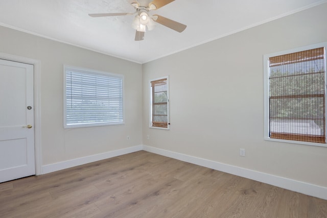 empty room with ornamental molding, ceiling fan, and light hardwood / wood-style flooring