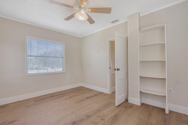 unfurnished bedroom featuring ceiling fan, crown molding, and light hardwood / wood-style floors