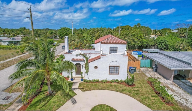 mediterranean / spanish house featuring a front yard