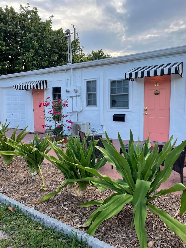 view of front of property featuring ac unit