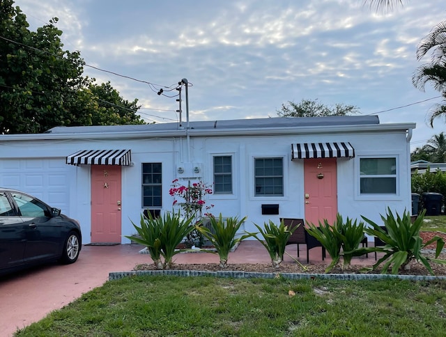 view of front of property with a front lawn and a garage