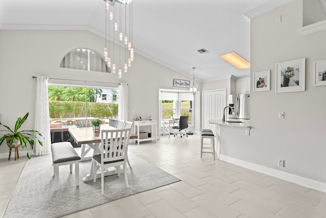 tiled dining space featuring high vaulted ceiling and ornamental molding