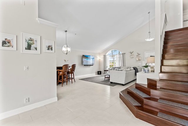 tiled living room with ornamental molding, high vaulted ceiling, and a chandelier