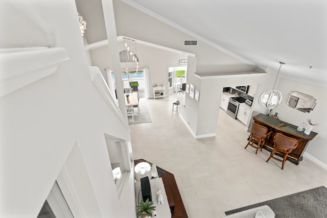 living room with crown molding, high vaulted ceiling, a chandelier, and light tile patterned floors