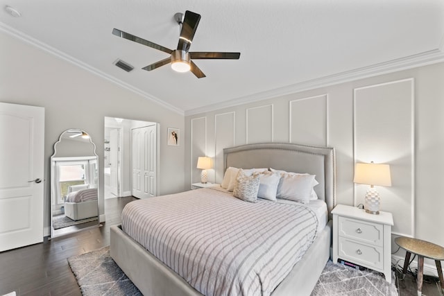 bedroom featuring ceiling fan, dark wood-type flooring, lofted ceiling, and ornamental molding