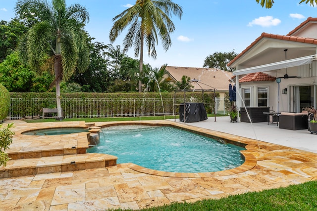 view of pool with a patio area, an in ground hot tub, and pool water feature