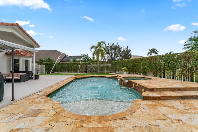 view of pool with pool water feature, outdoor lounge area, an in ground hot tub, and a patio