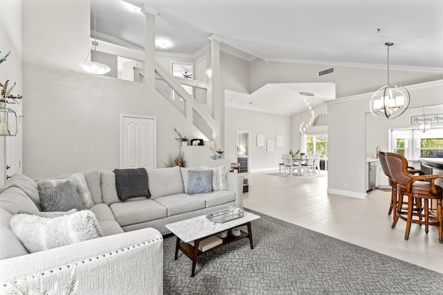 tiled living room with crown molding, high vaulted ceiling, and a chandelier