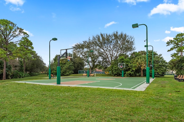 view of sport court with a yard