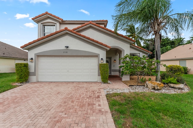 mediterranean / spanish-style house with a garage