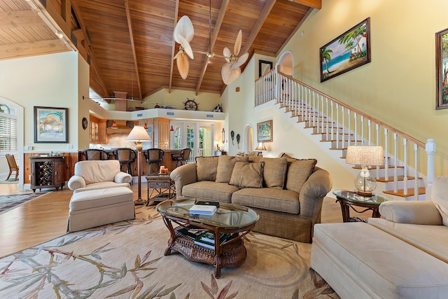 living room featuring wooden ceiling, high vaulted ceiling, ceiling fan, beamed ceiling, and light hardwood / wood-style floors