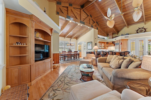 living room featuring beamed ceiling, light wood-type flooring, and wooden ceiling