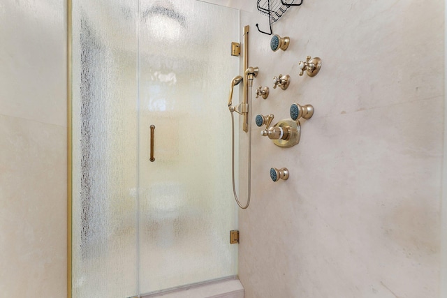 bathroom with a shower with shower door