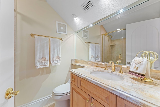 bathroom featuring vanity, a shower with shower door, lofted ceiling, and toilet