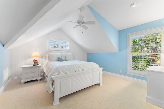 bedroom featuring light carpet, vaulted ceiling, and ceiling fan